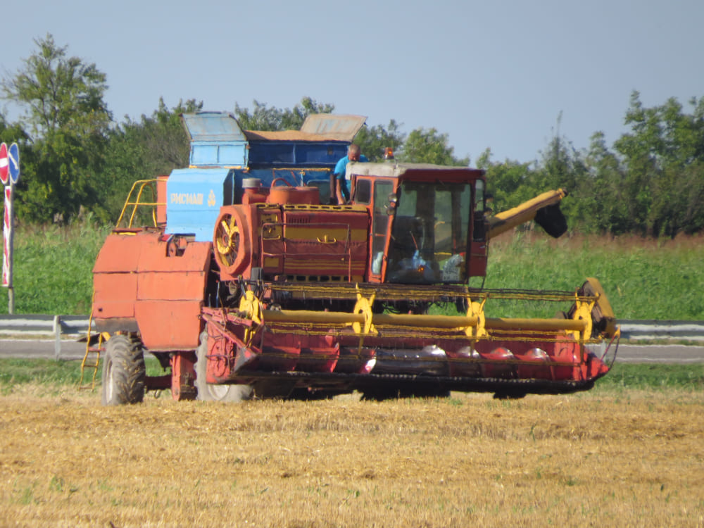 Red combine in a field